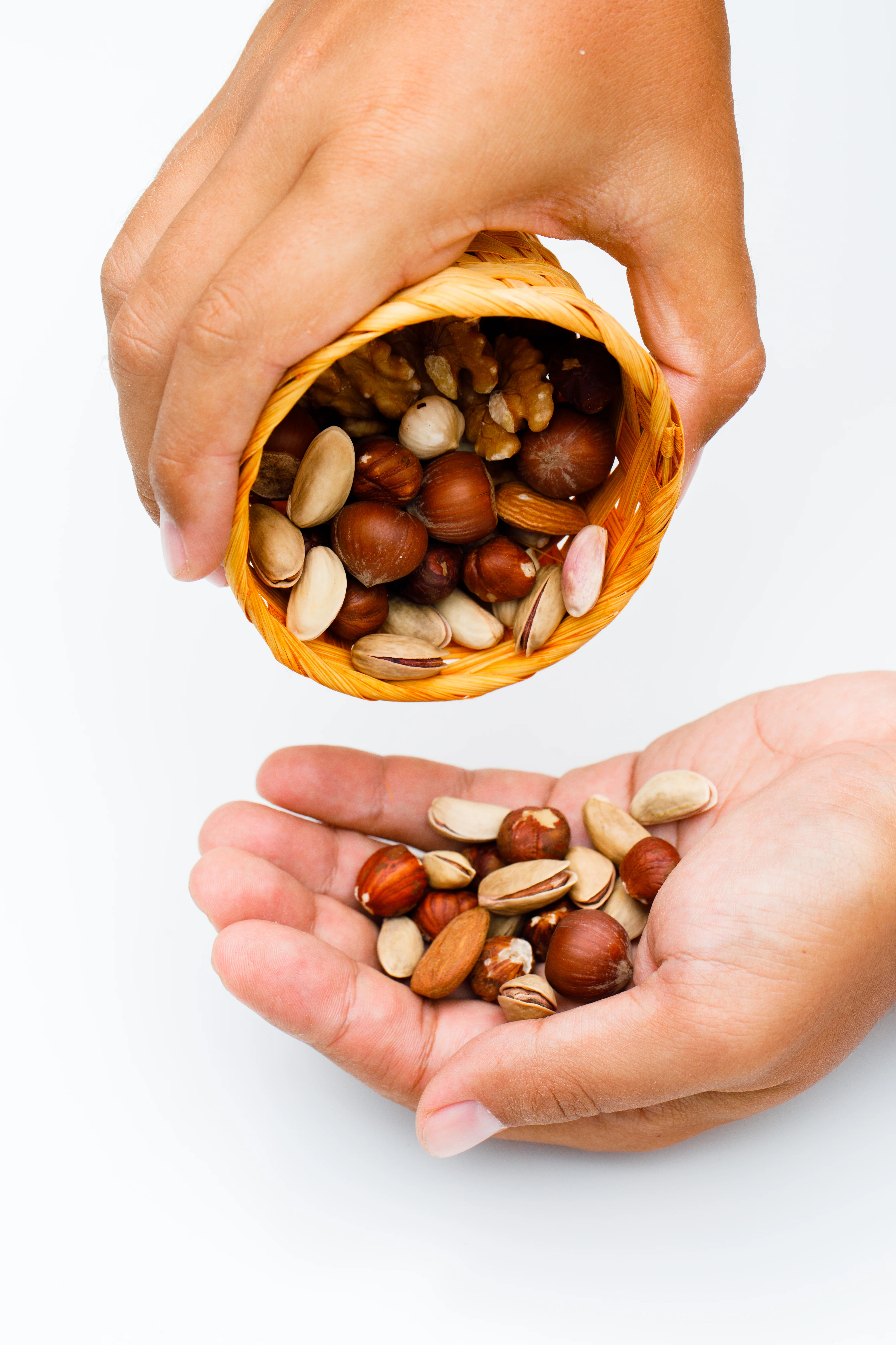 Hands pouring premium dry fruits